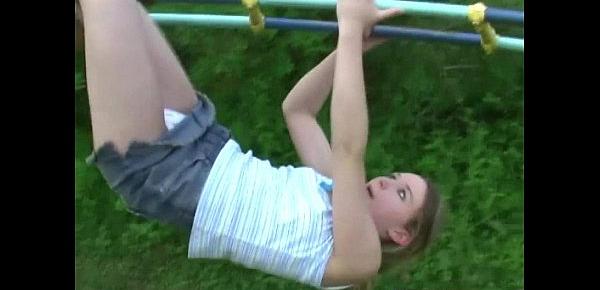  Young teen plays in the park and flashes her body